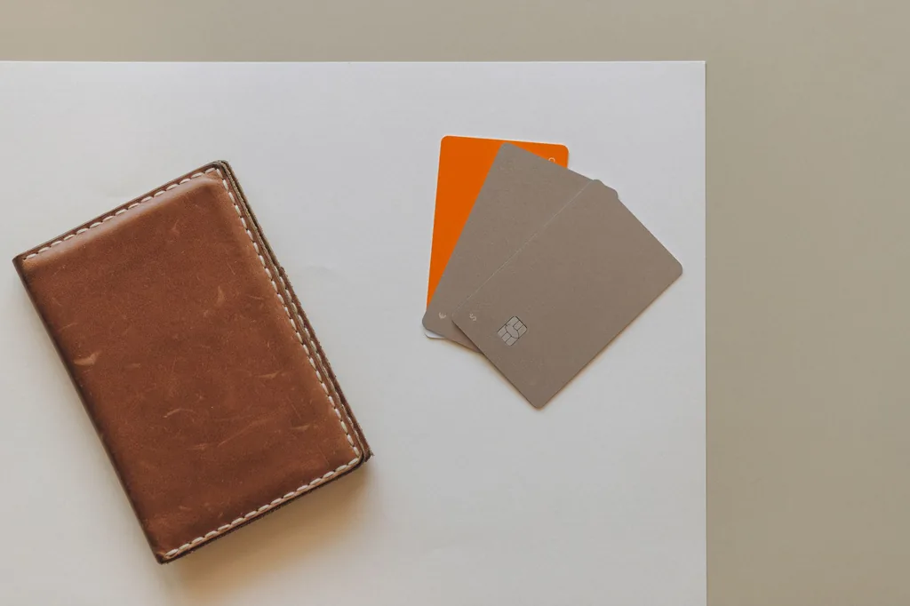 Leather wallet and credit cards on a table, a reminder to keep balances low to improve your credit score